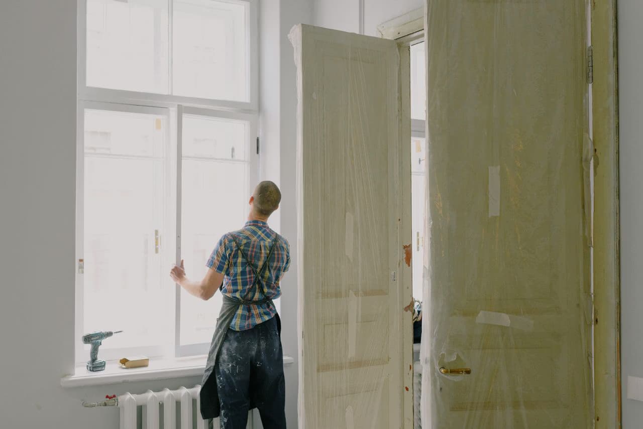 Contractor installing a custom wood window on a jobsite